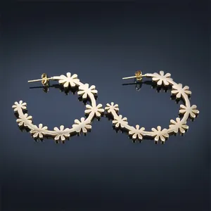 Chic gold daisy flower curved hoop earrings with polished floral stud design for women