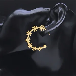 Elegant gold flower hoop earrings with daisy petals on black display for women