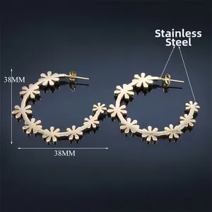 Golden stainless steel large C-shaped hoop earrings with hollow flower pattern design