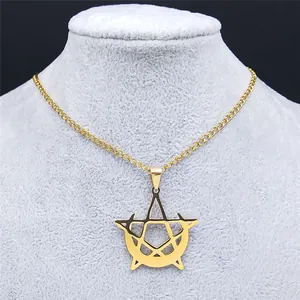 Close-up of gold pentagram and crescent moon pendant necklace on a jewelry display stand