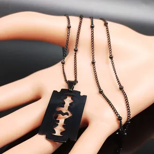 Collana con ciondolo a lama di rasoio nero opaco stile punk con catena a sfere su mano