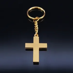 Golden stainless steel cross keychain with reflective metallic finish on black background