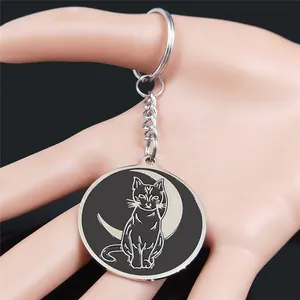 Mysterious moon cat stainless steel keychain with black enamel finish in hand