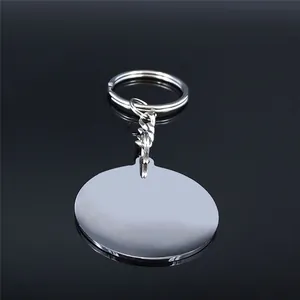 Polished stainless steel moon cat keychain with a round blank pendant on a black mirror