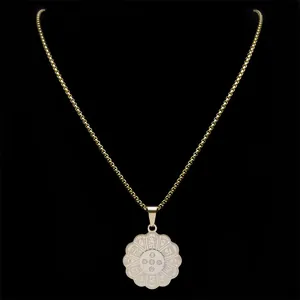Golden stainless steel mandala pendant necklace with Sanskrit engraving on black background