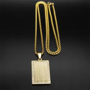 Macro detail of 18k gold-plated rectangular Buddhist pendant with rows of scriptures