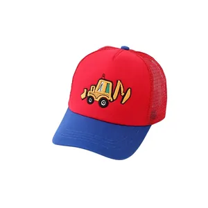 Detailed view of the yellow excavator embroidery on the red and blue mesh trucker hat