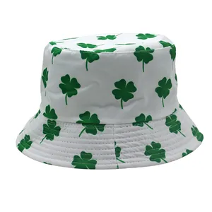 Close-up of green clover print on white cotton bucket hat with parallel stitched brim