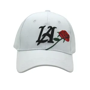 White baseball cap featuring red rose embroidery and LA script lettering on the front