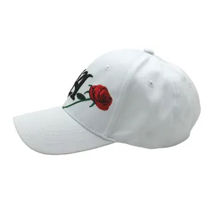 Detail of white cotton baseball cap with NY letter and red rose flower embroidery