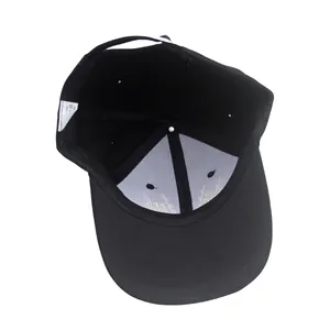 Interior view of black cotton baseball cap featuring reinforced structure and adjustable strap
