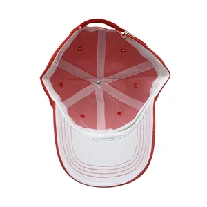 Inside view of red polyester baseball cap showing white support structure and adjustable strap