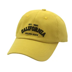 Close-up of vintage California embroidery and stitching details on a yellow cotton baseball cap