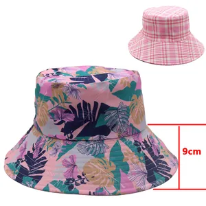 Detail of 9cm wide brim on reversible bucket hat with tropical leaf print and pink checkers