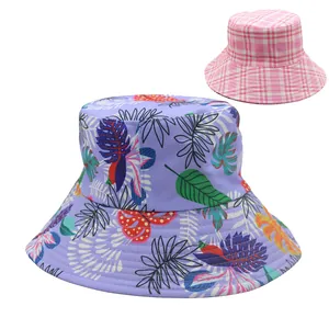 Reversible wide brim sun hat for women featuring tropical leaf prints and classic plaid pattern