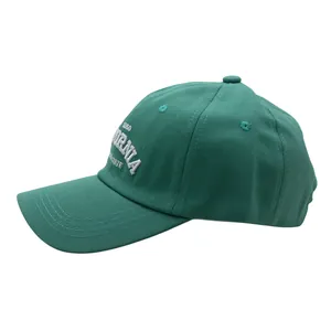 Detailed close-up of 3D embroidery and twill cotton texture on green baseball cap