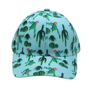 Detail of light blue baseball cap featuring vibrant cactus print and textured fabric
