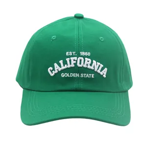 Detailed close-up of green baseball cap with white 3D embroidery and cotton texture