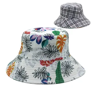 Close-up of sun hat featuring colorful tropical leaf prints and classic plaid pattern texture