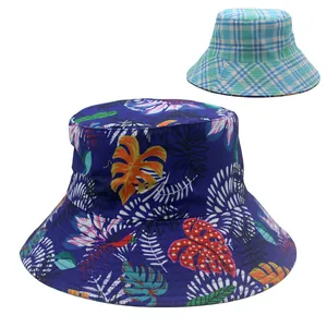 Reversible wide brim sun hat with tropical leaf print and blue plaid patterns