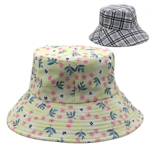 Close-up of reversible sun hat with pink floral patterns and classic grey plaid design