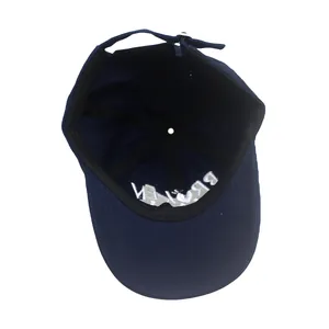 Detail view of navy blue baseball cap interior with sweatband and BROKEN embroidery