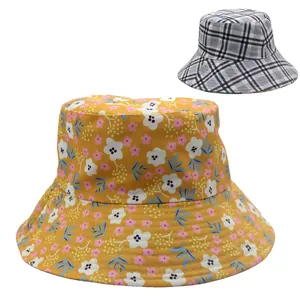 Detail view of floral and plaid pattern sun hats showing cotton texture and wide brim