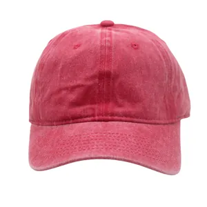 Close-up of vintage washed red baseball cap showing fabric texture and curved brim detail