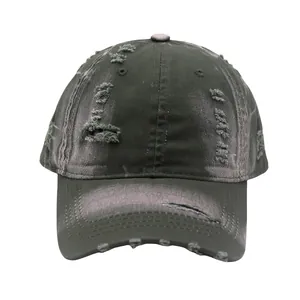 Close-up of distressed vintage basecap showing frayed holes and washed canvas texture