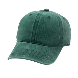 Detailed view of dark green washed cotton canvas texture and breathable vent eyelets on hat