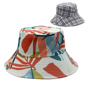 Detail of reversible bucket hat showing tropical leaf prints and classic plaid pattern