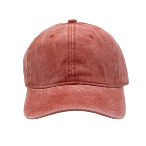 Close-up of vintage washed red cotton baseball cap showing detailed texture and stitching