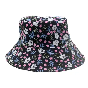 Close-up of wide brim sun hat with pink and white floral patterns on black fabric