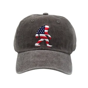 Close-up of distressed cotton baseball cap featuring detailed Bigfoot flag embroidery