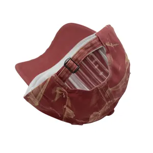 Rear detail of distressed red baseball cap featuring adjustable bronze metal buckle and texture