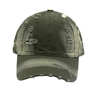 Close-up of distressed army green baseball cap with ripped details and faded vintage effect