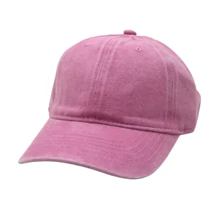 Detail view of pink washed cotton baseball cap showing six-panel crown and stitched brim