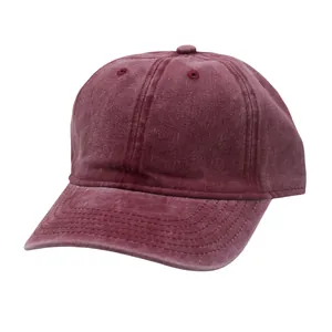 Detailed view of burgundy washed cotton baseball cap texture and breathable eyelets