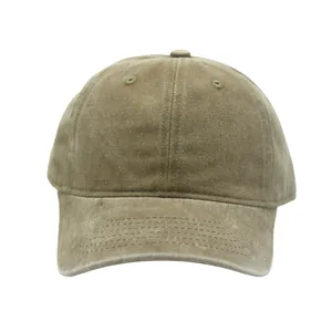 Detail of vintage washed cotton fabric texture and ventilation holes on a green baseball cap