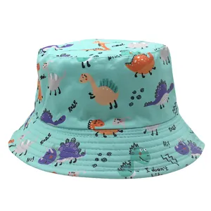 Detail of mint green bucket hat featuring colorful cartoon dinosaur prints and text