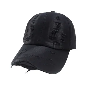 Close-up of distressed vintage black baseball cap featuring ripped details and washed fabric