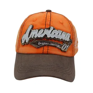 Macro detail of Americana vintage embroidery on orange and brown washed cotton cap
