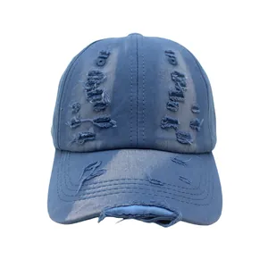 Distressed washed denim baseball cap in vintage blue with retro ripped hole details