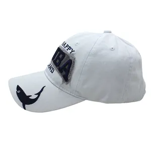 Close-up of a white cotton baseball cap with blue shark embroidery and happy patch