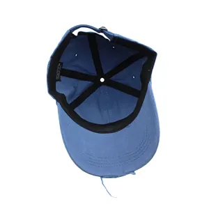 Detail view of washed denim baseball cap featuring distressed edges and cotton lining