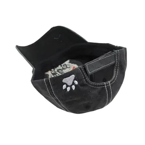 Detail of washed black baseball cap with grey paw embroidery and adjustable velcro closure