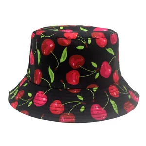 Detailed close-up of cherry pattern print on a black cotton bucket hat with stitching
