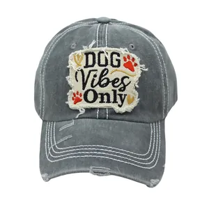 Detail of grey washed cotton cap featuring frayed patch and DOG Vibes Only embroidery