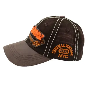 Detail of vintage washed baseball cap with orange 3D embroidery and white contrast stitching