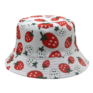 Detail of white bucket hat with red strawberry prints and reinforced stitching on brim